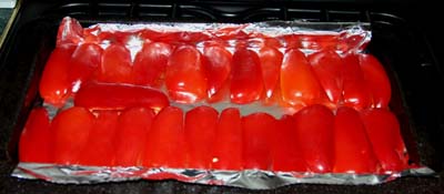 The peppers cut, trimmed and laid out in the grill-pan