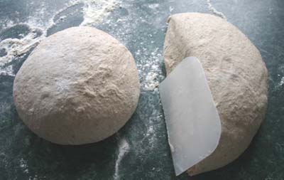 The dough halved for the first time using the scraper