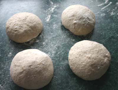 The dough halved and rounded into four pieces