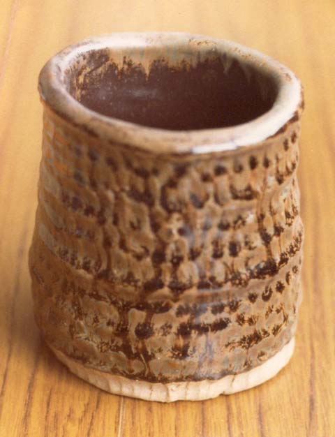 A coiled pot in tenmoku and oatmeal